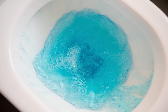 flushing a closestool with blue water