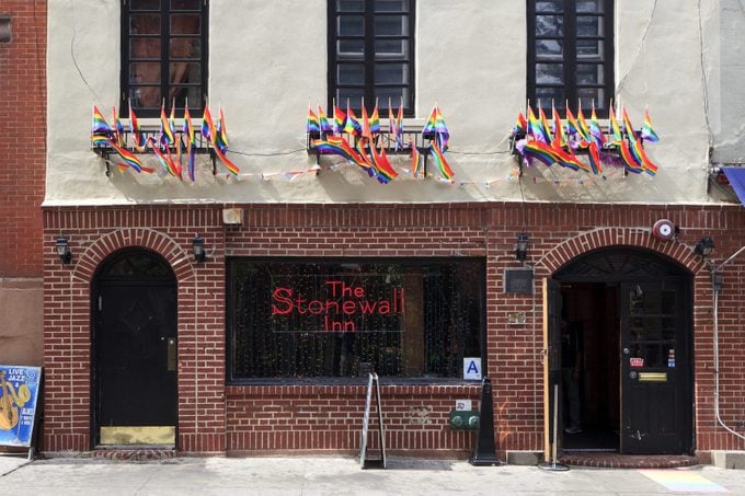 The Stonewall Inn in new york city adorned with various pride flags