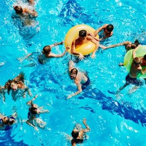 Group of kids playing together in outdoor pool