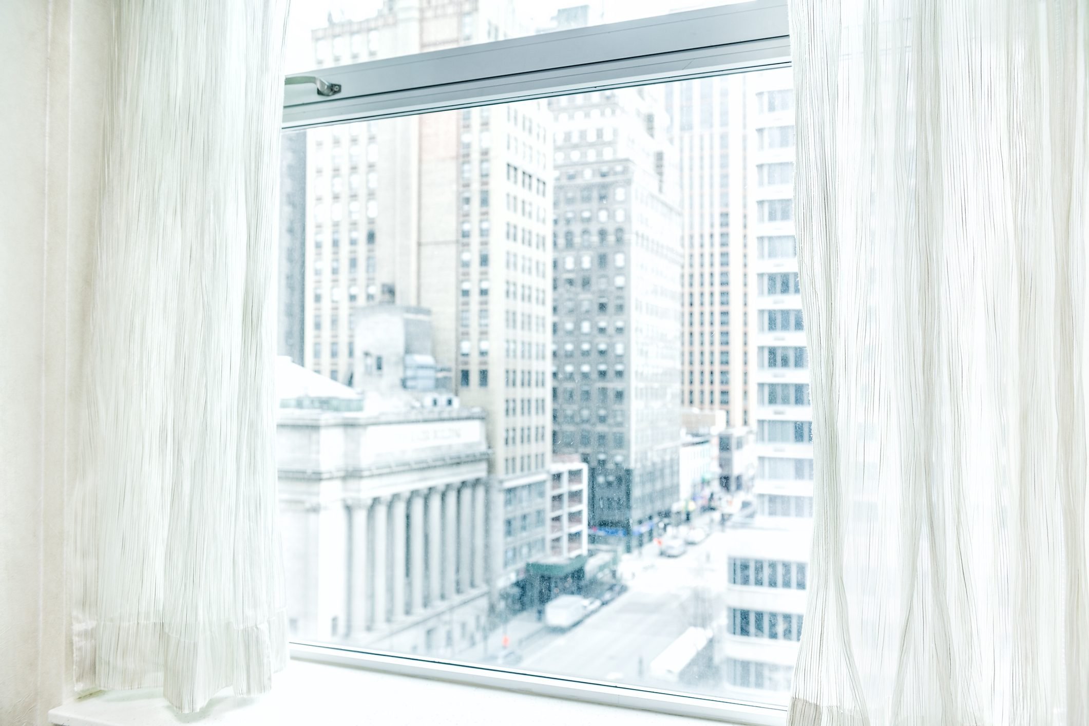 Window blinds curtains with view looking at midtown New York City NYC cityscape skyline in Manhattan hotel, apartment condo high rise building