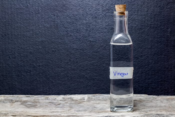 white vinegar on the wooden table