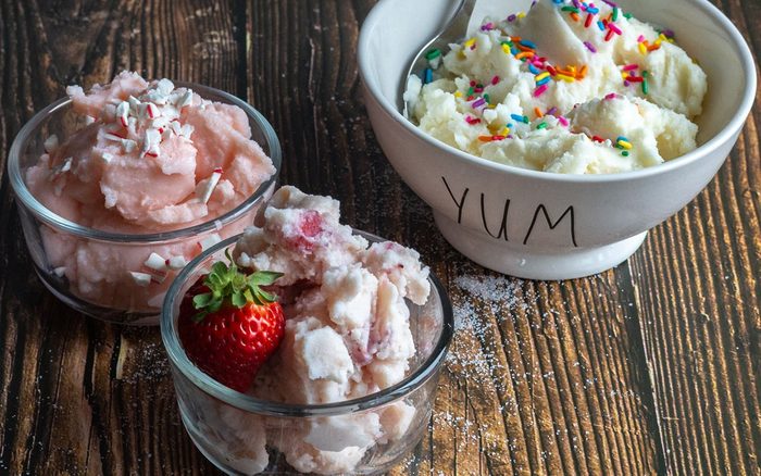Strawberry, vanilla and peppermint ice cream in dishes.