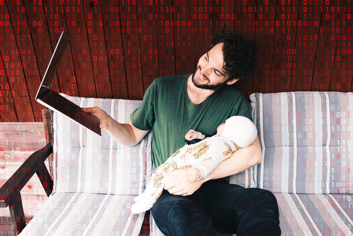 man holding baby using zoom; computer code overlay