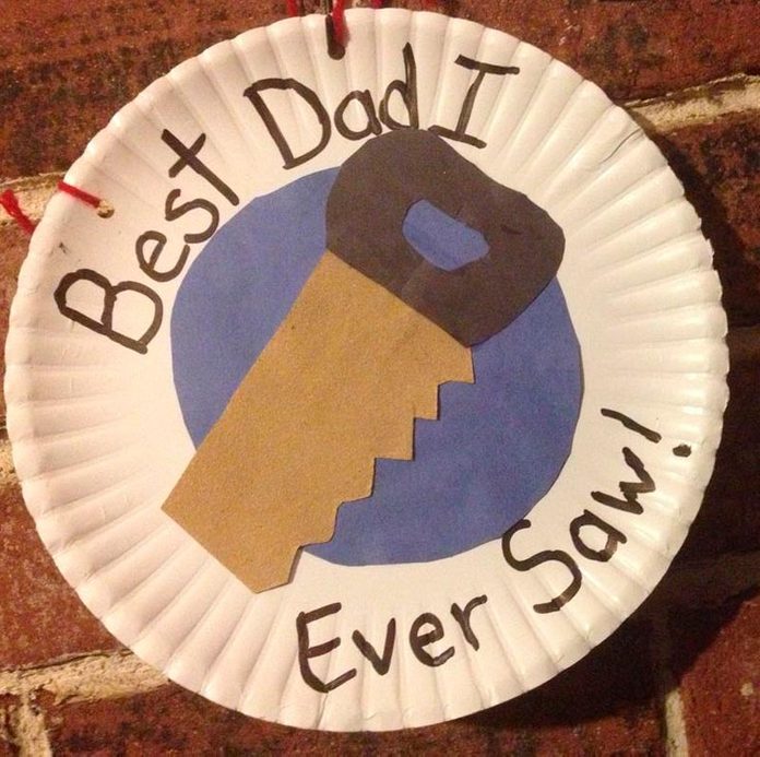 Fathers Day Craft with a construction paper saw on a paper plate