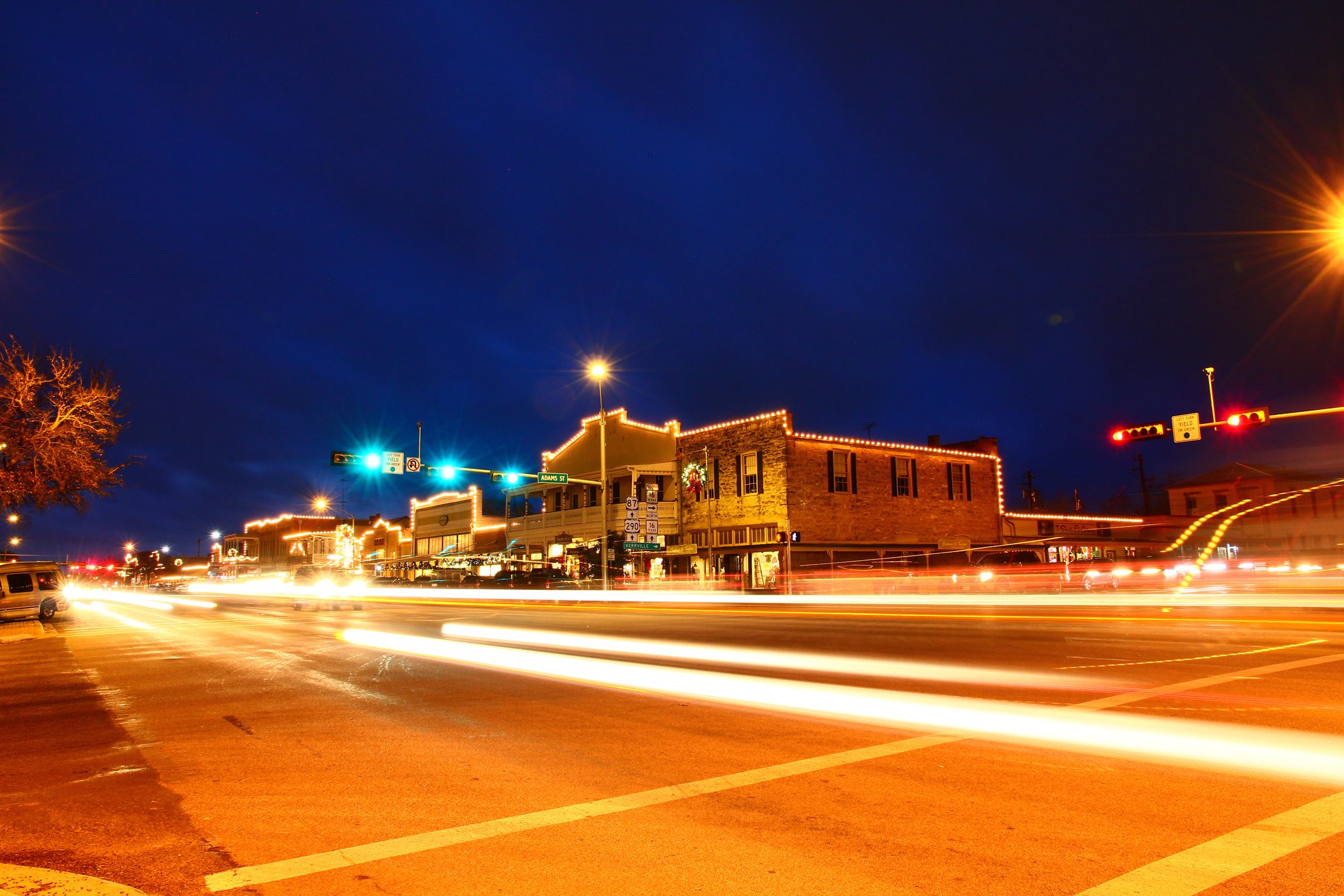 Beautiful city night scape of road and land transportation against lighting in Fredericksburg of Texas