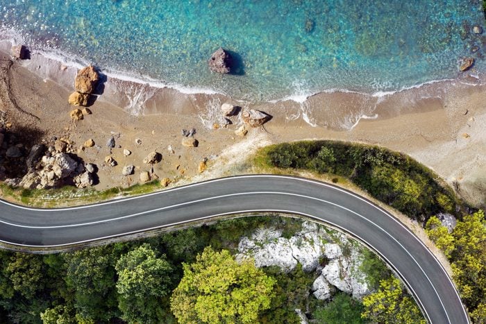 Seaside road approaching a beach, seen from above
