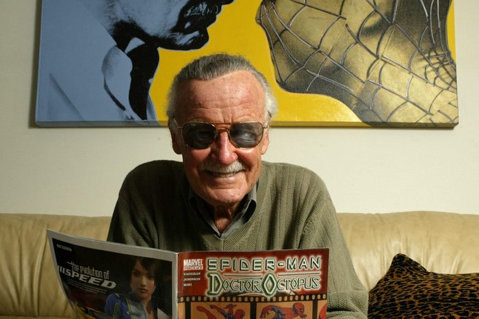Stan Lee reading a magazine