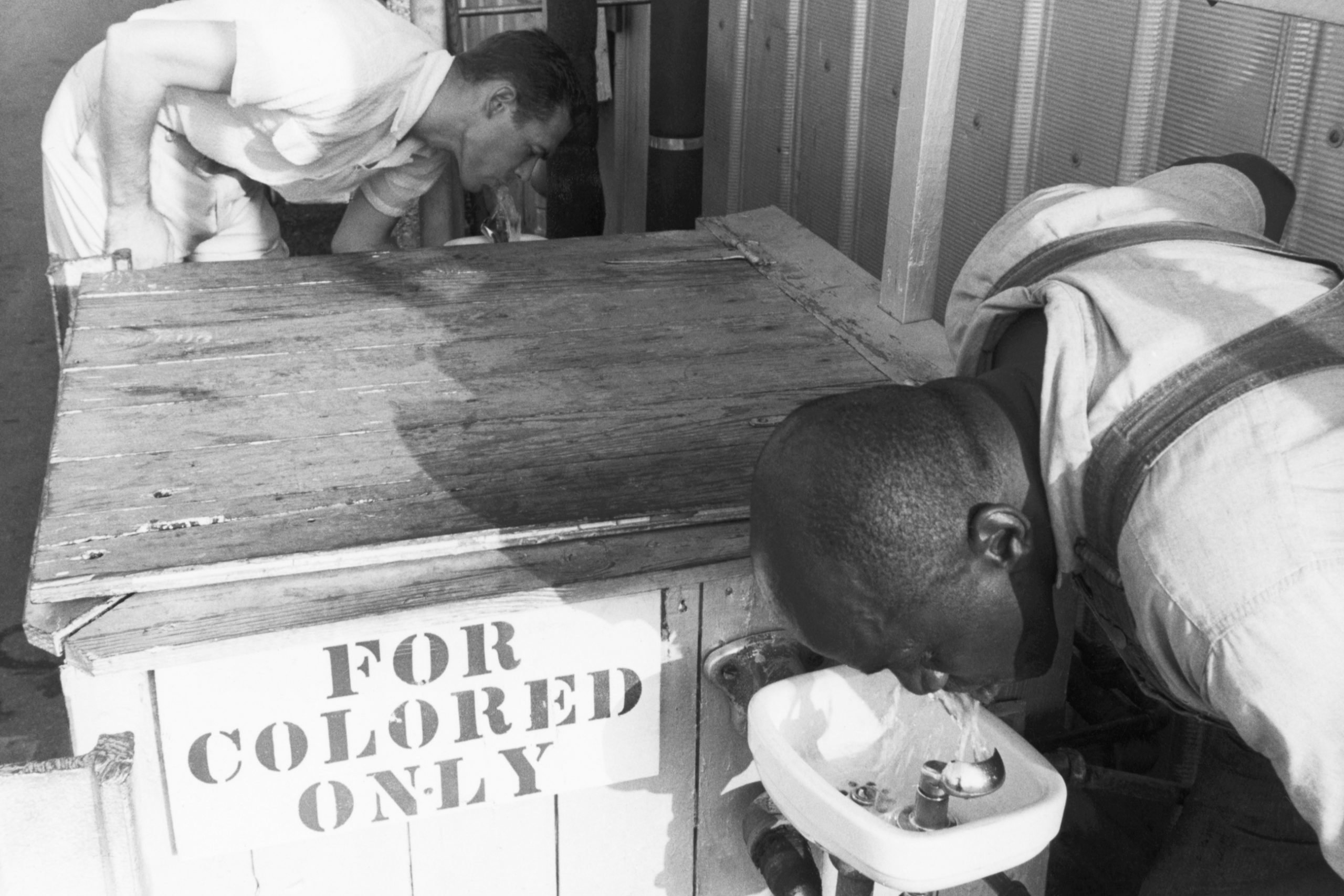 Men Drinking from Segregated Water Fountains