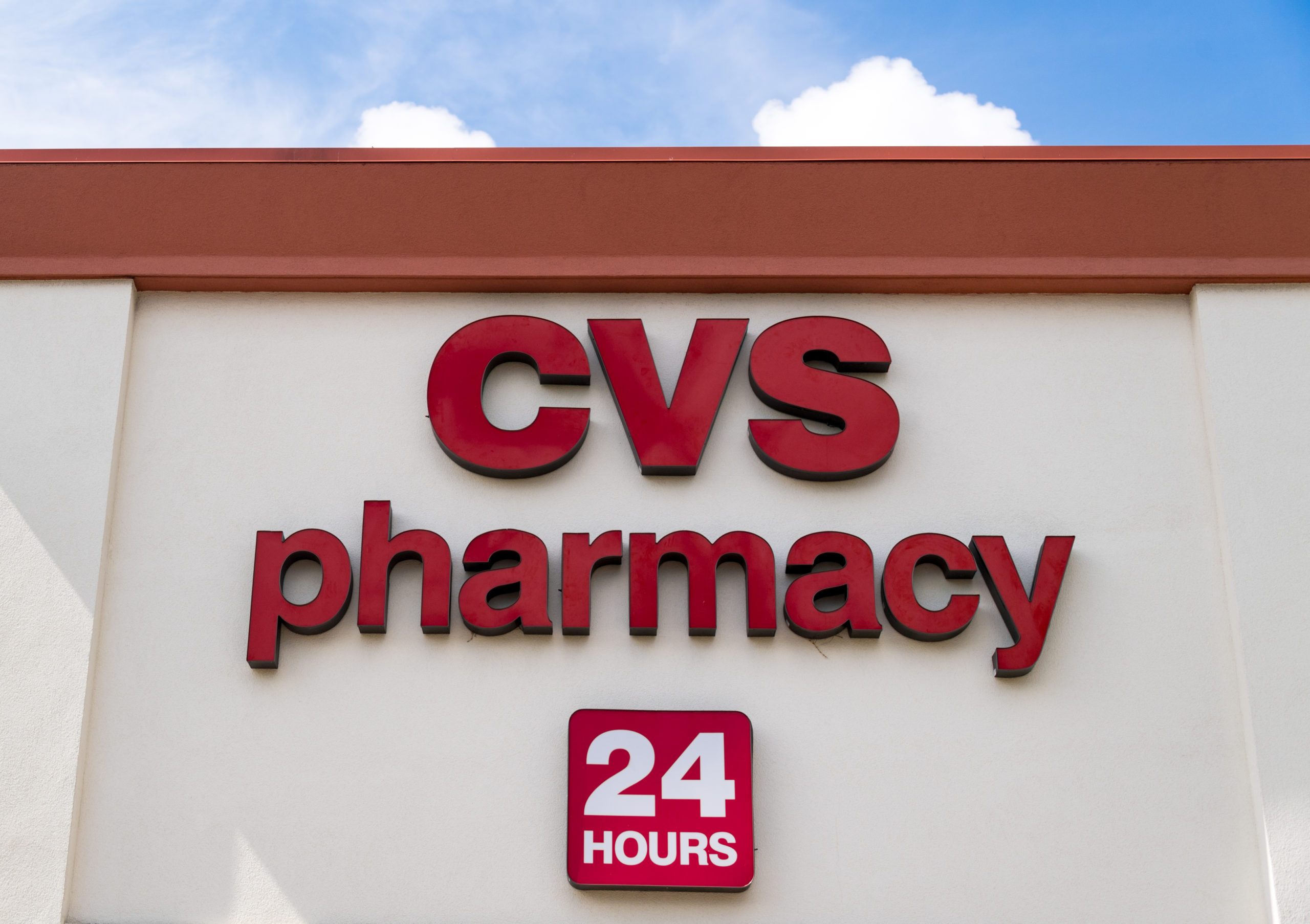 Red metal signage of CVS pharmacy, a 24 hours open medical...