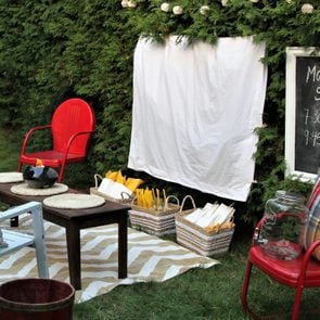 Set up for watching a movie outdoors with food and chairs