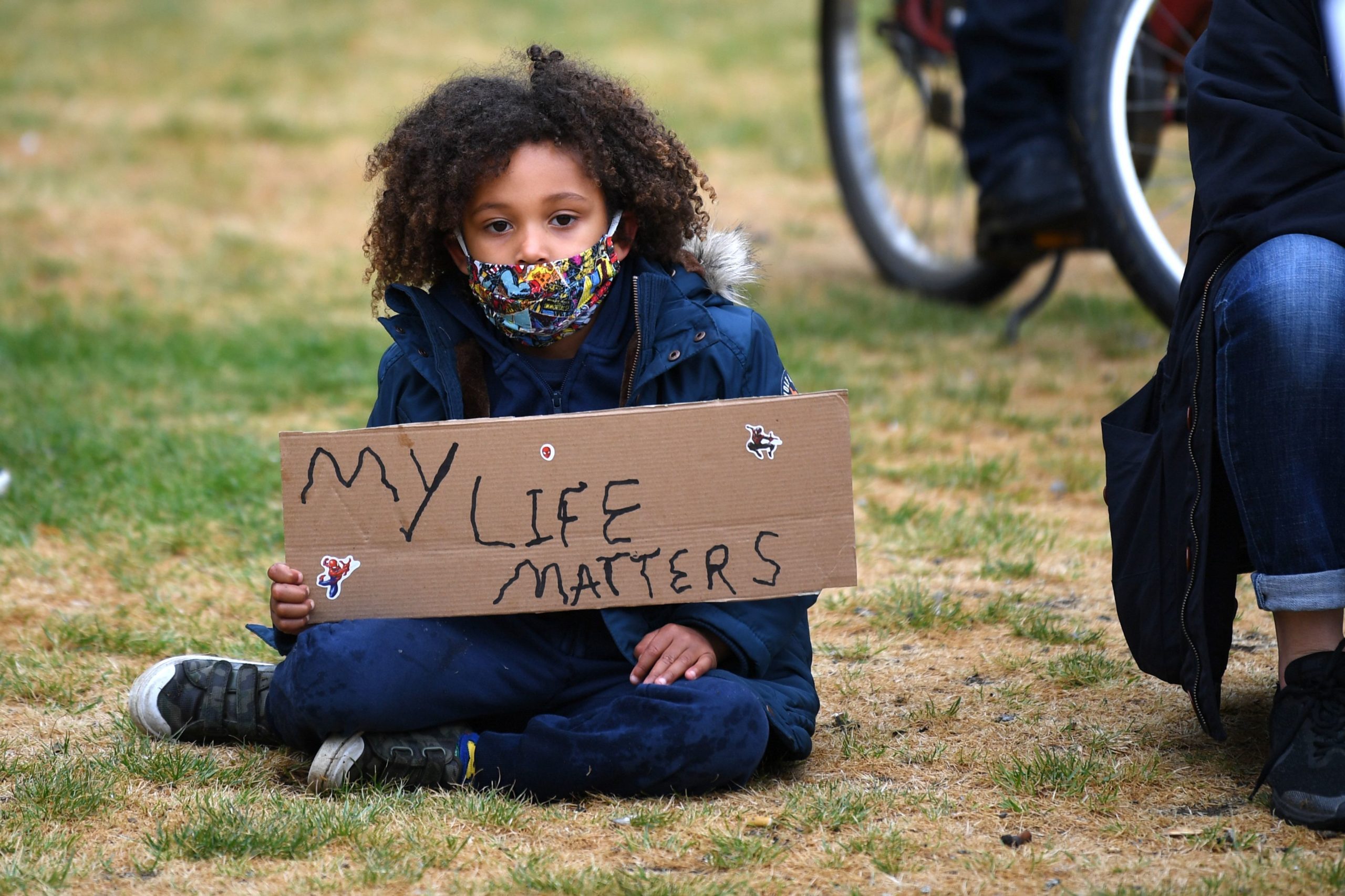 A young girl prepares for the Take The Knee demonstration in solidarity with Black Lives Matter in Windrush Square, Brixton, south west London on June 10, 2020. - Britain has seen days of protests sparked by the death in police custody of George Floyd, an unarmed black man, in the United States. (Photo by DANIEL LEAL-OLIVAS / AFP) (Photo by DANIEL LEAL-OLIVAS/AFP via Getty Images)