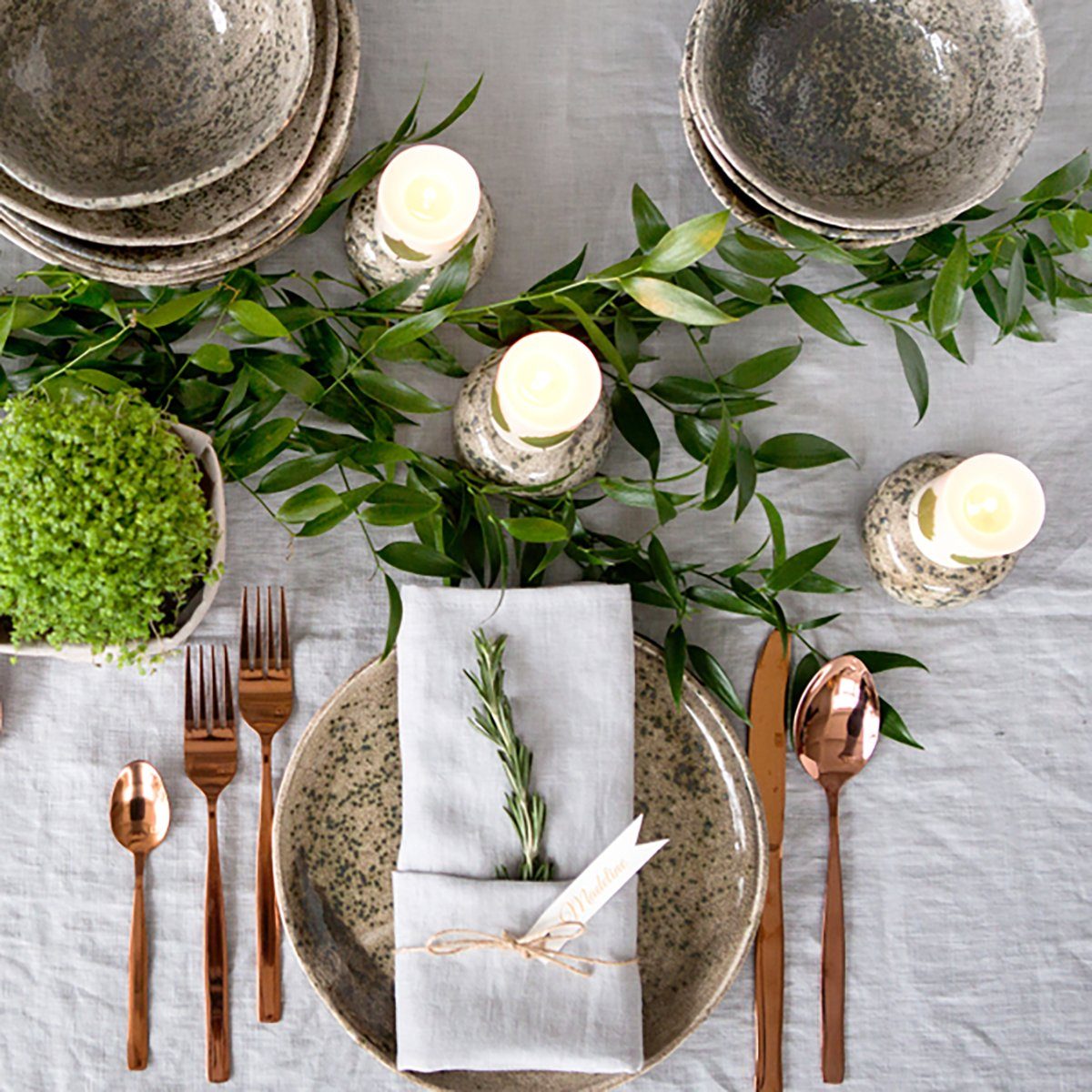 Holiday table setting with Linen napkins and rose gold cutlery