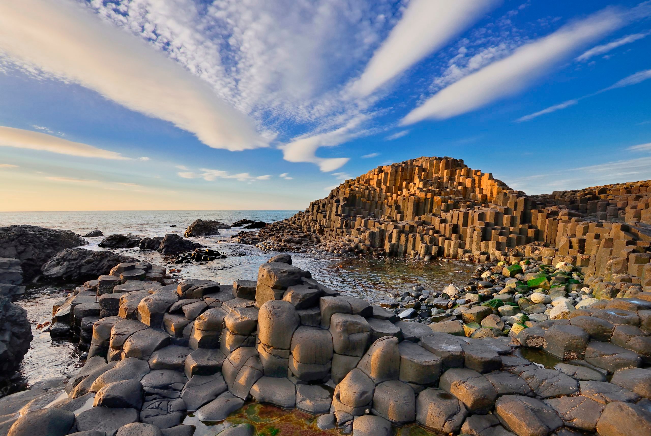 Ireland. County Antrim. Giants Causeway. Dramatic cloud pattern over the rocks at sunset.