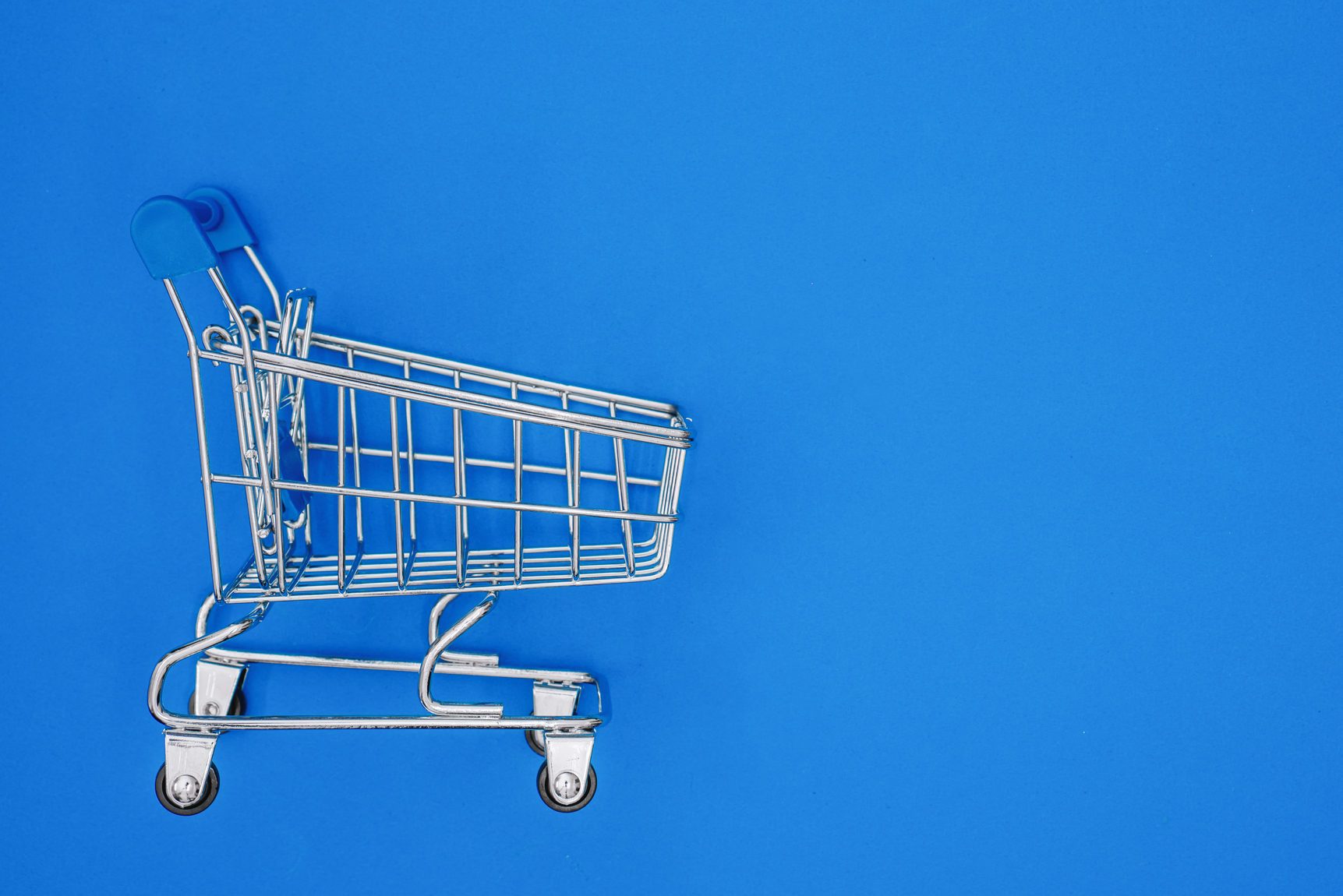 Mini Shopping Cart on Blue Background