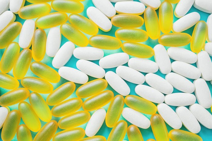 Large medical capsules and tablets-vitamins and nutritional supplements on a blue background. Close up. Selective focus