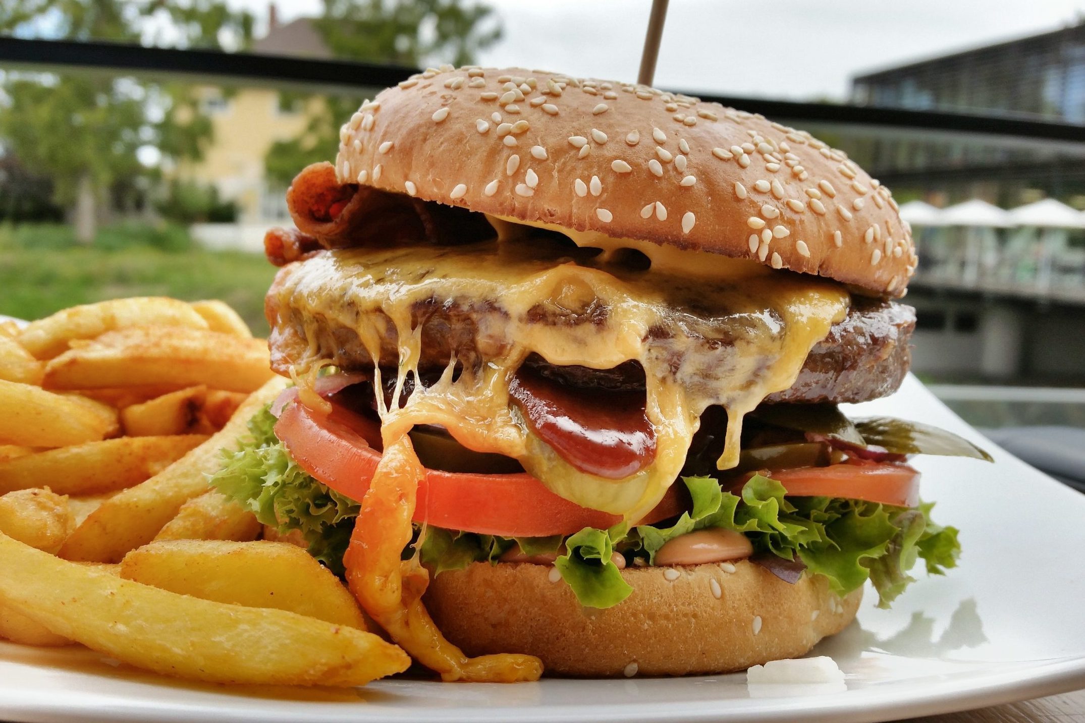 Close-Up Of Burger With French Fires Served In Restaurant