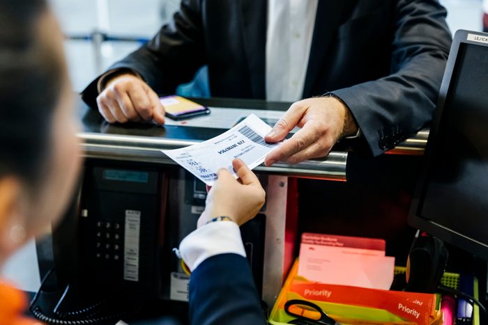 Businessman getting his boarding pass at check-in counter