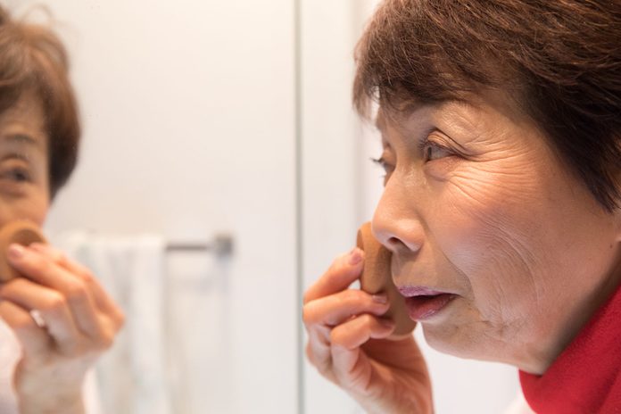 Japanese senior woman putting make up