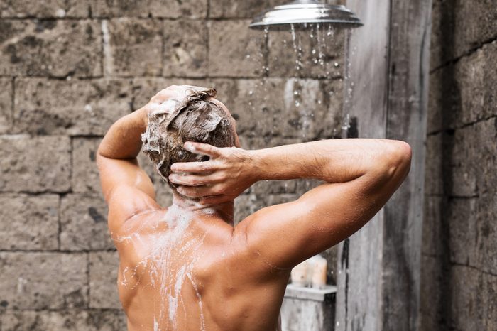 Man taking shower and washing hair