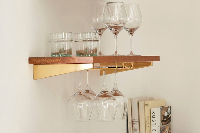 wine glasses hanging from shelf in kitchen