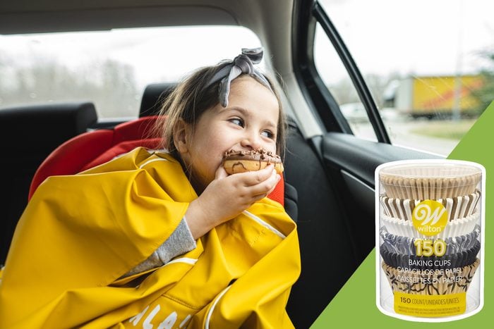 child eating in the backseat of car with inset of cupcake holders
