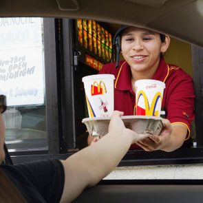 REDWOOD CITY, CA - JULY 29: Josephine Hernandez hands a tray of drinks to a drive thru customer at a McDonald's restaurant July 29, 2003 in Redwood City, California. McDonald's Corporation today reported record second quarter and first half U.S. sales spurred by enthusiasm for its new food offerings and improvement in food taste and service initiatives. Despite the significantly stronger U.S. sales, McDonald?s global profits fell 5 percent as sales in its restaurants in Europe and Asia remained flat.(Photo by Justin Sullivan/Getty Images)