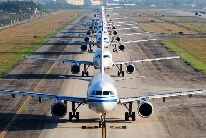 so many airplanes are in line on the runway waiting for take off