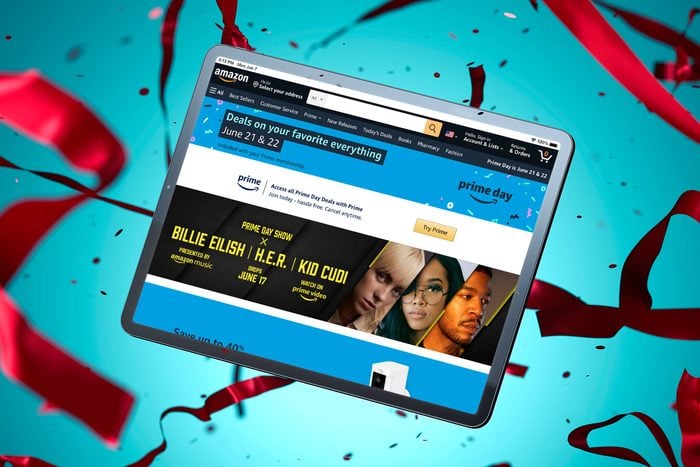 amazon.com primeday screen shown on a table floating amont confetti and ribbon with a blue background