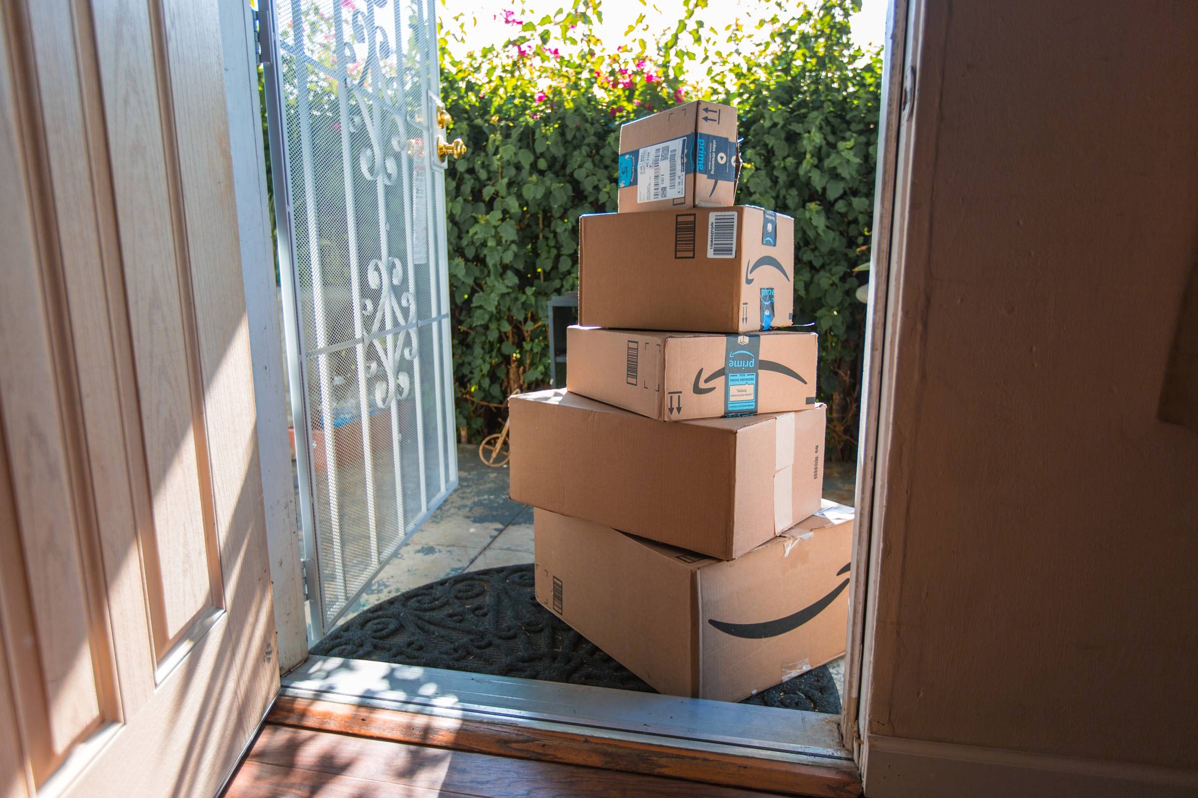 large stack of amazon packages at someones front door