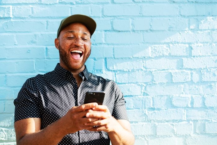 Man laughing with smart phone