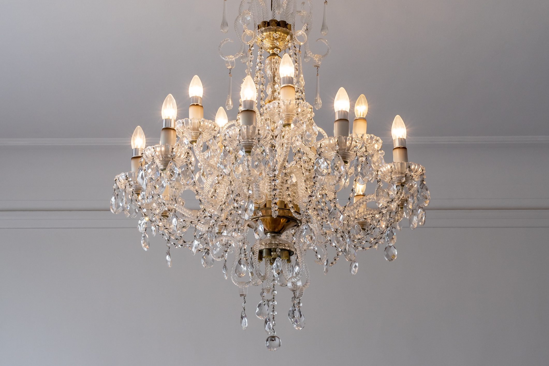 Low Angle View Of Illuminated Chandelier Hanging From Ceiling