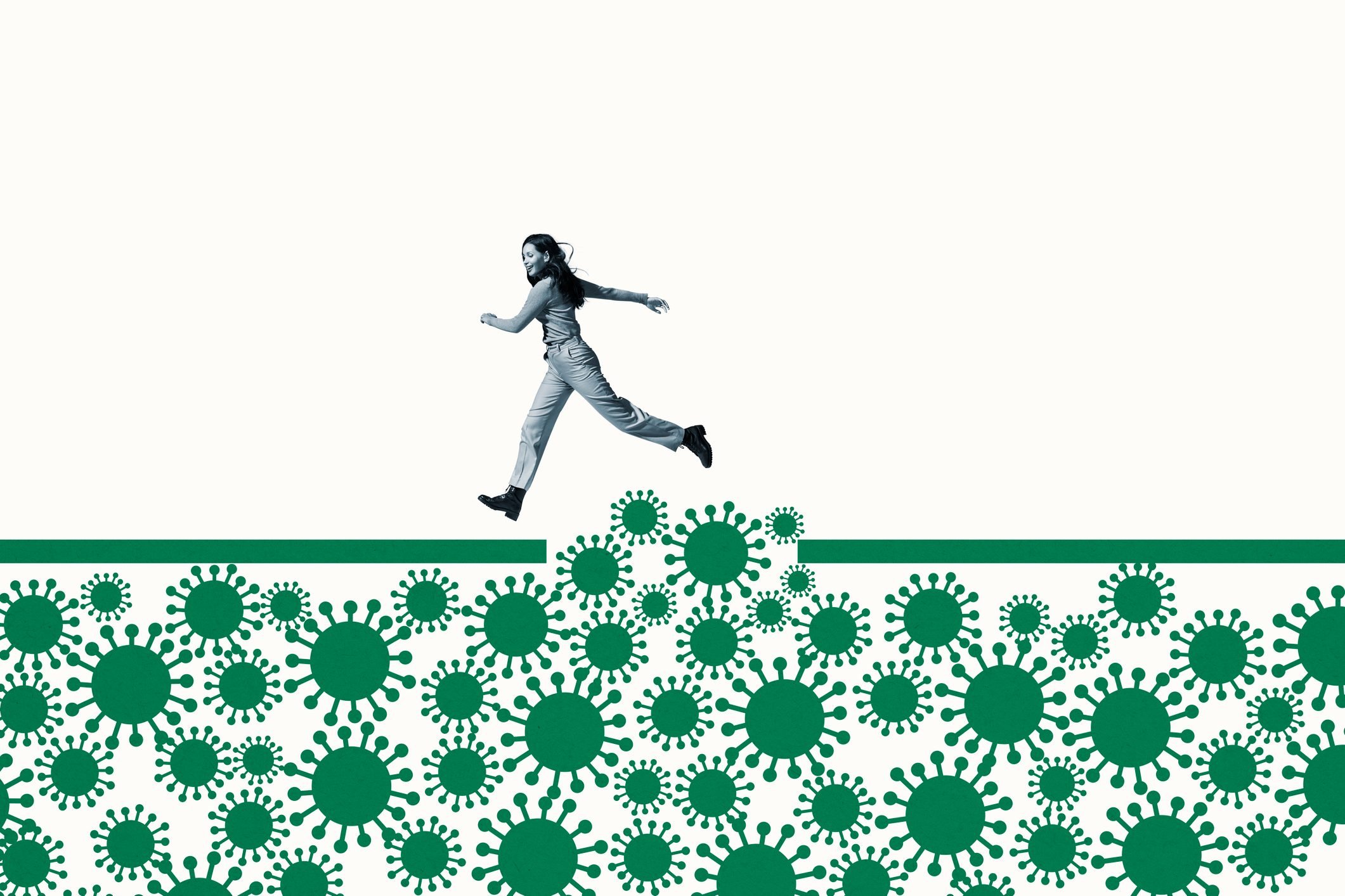Woman jumping over green coronavirus under ramp