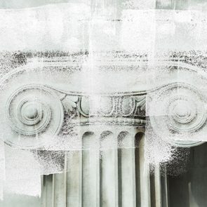 white paint overlay over a close up of details of a marble column