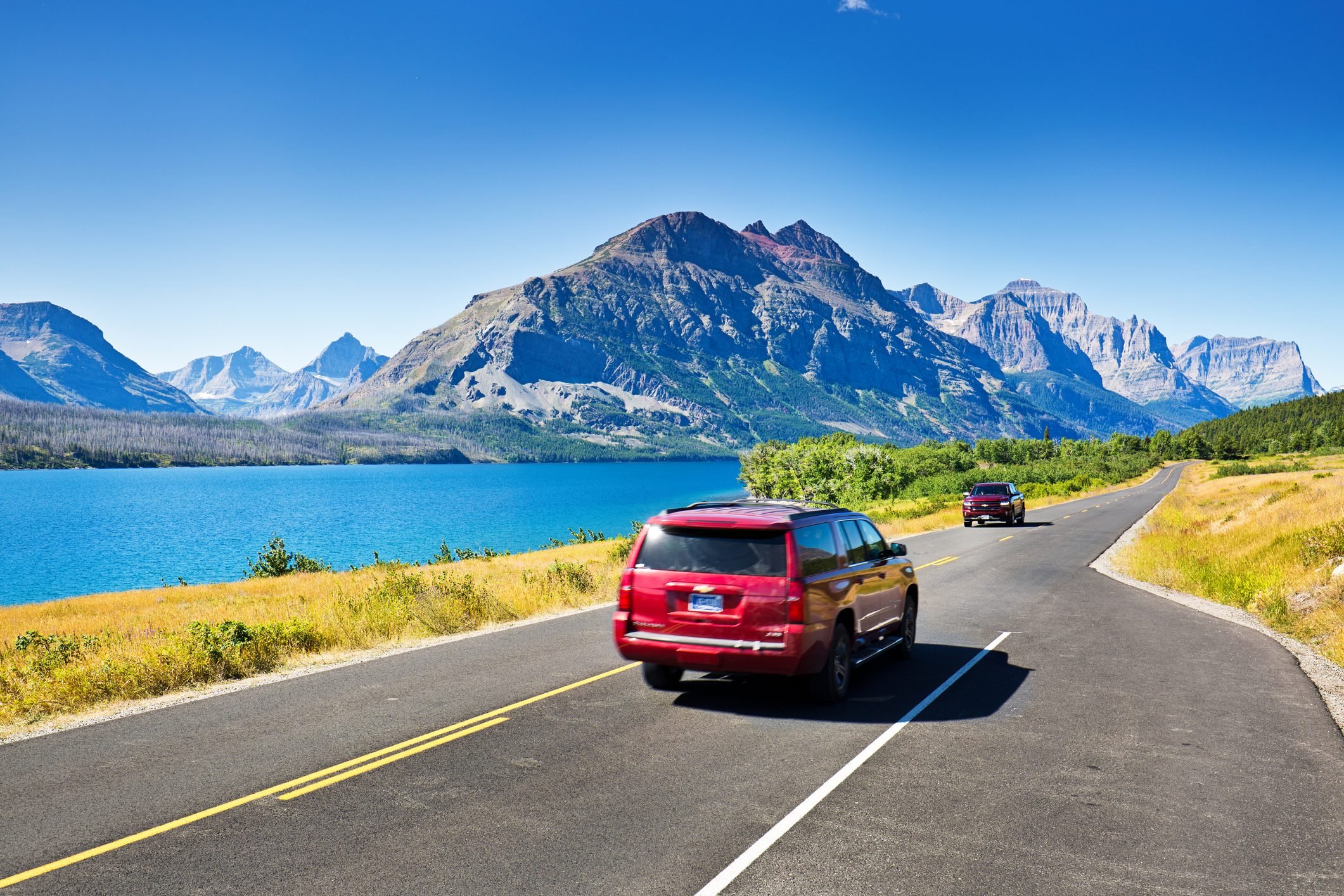 Tourists Touring Glacier National Park in a Driving Road Trip