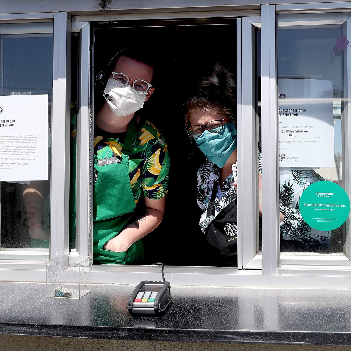 EDGEWATER, COLORADO - APRIL 07: Starbucks employees wear a mask while working the drive-thru window on April 07, 2020 in Edgewater, Colorado. Starting today Starbucks will require all employees to wear facemasks at work. The chain has closed in-store cafes however drive-thru locations remain open. (Photo by Matthew Stockman/Getty Images)