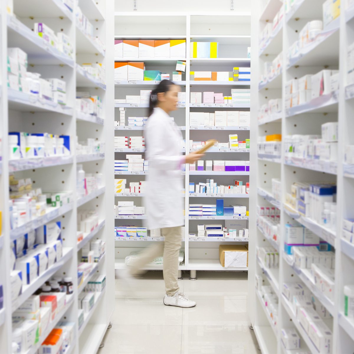 Pharmacist walking through pharmacy