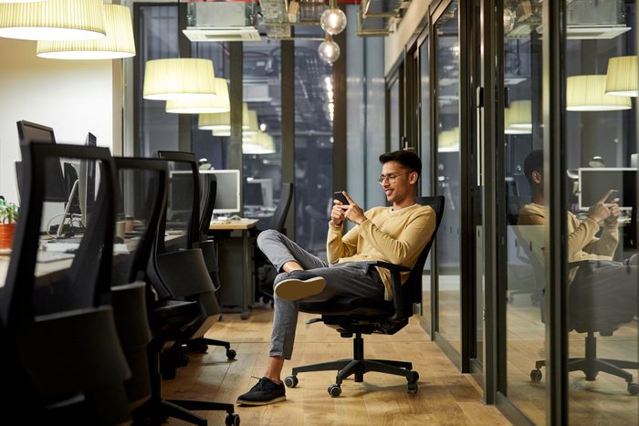 Businessman using mobile phone in creative office