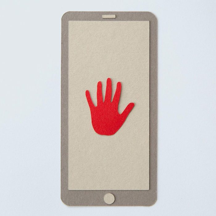 paper smart phone with a red hand