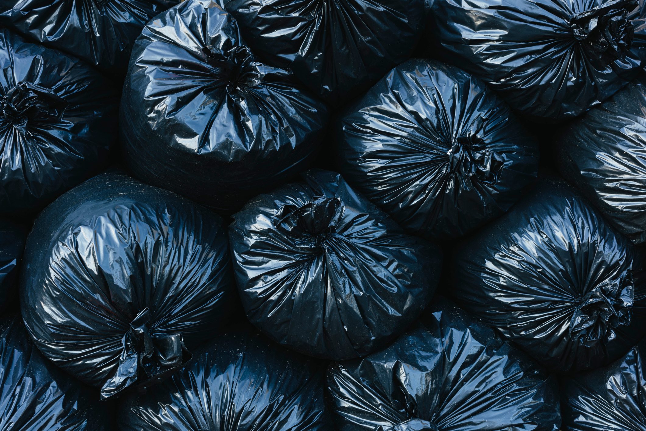 Pile of black plastic garbage bags.