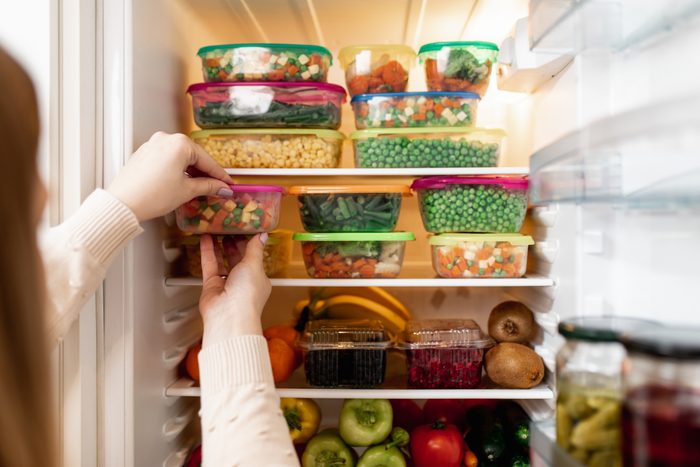 Woman taking raw food from refrigerator