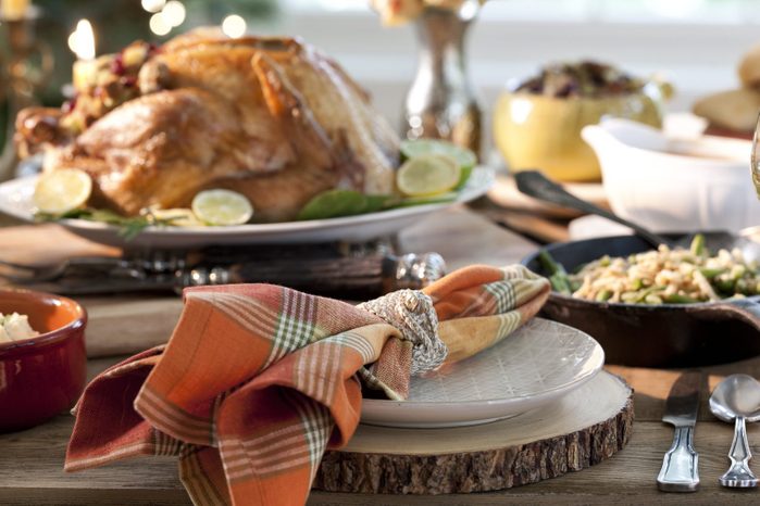 thanksgiving dinner table with sliced wood chargers