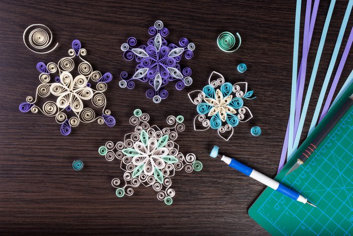 Handmade paper snowflakes with tools for quilling