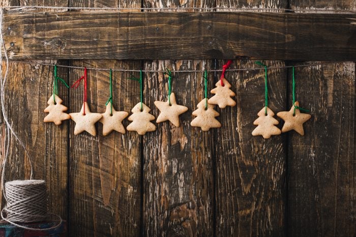 Christmas homemade gingerbread cookies on rustic wooden background with copy-space