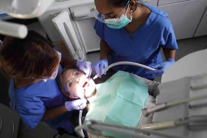 Dentist working on patient in chair