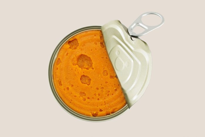 canned pumpkin on a tan background