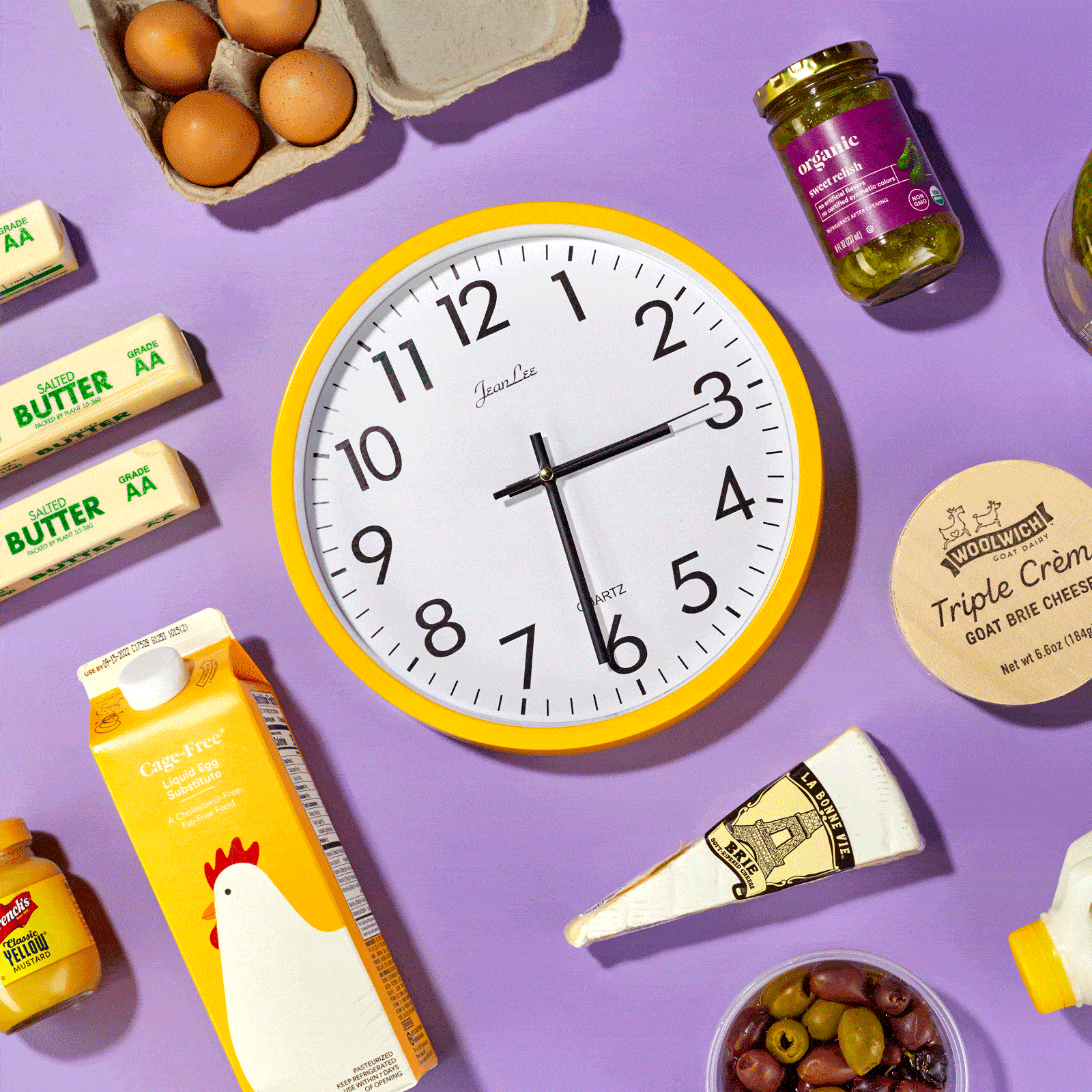 time elapsing on clock surrounded by perishable foods