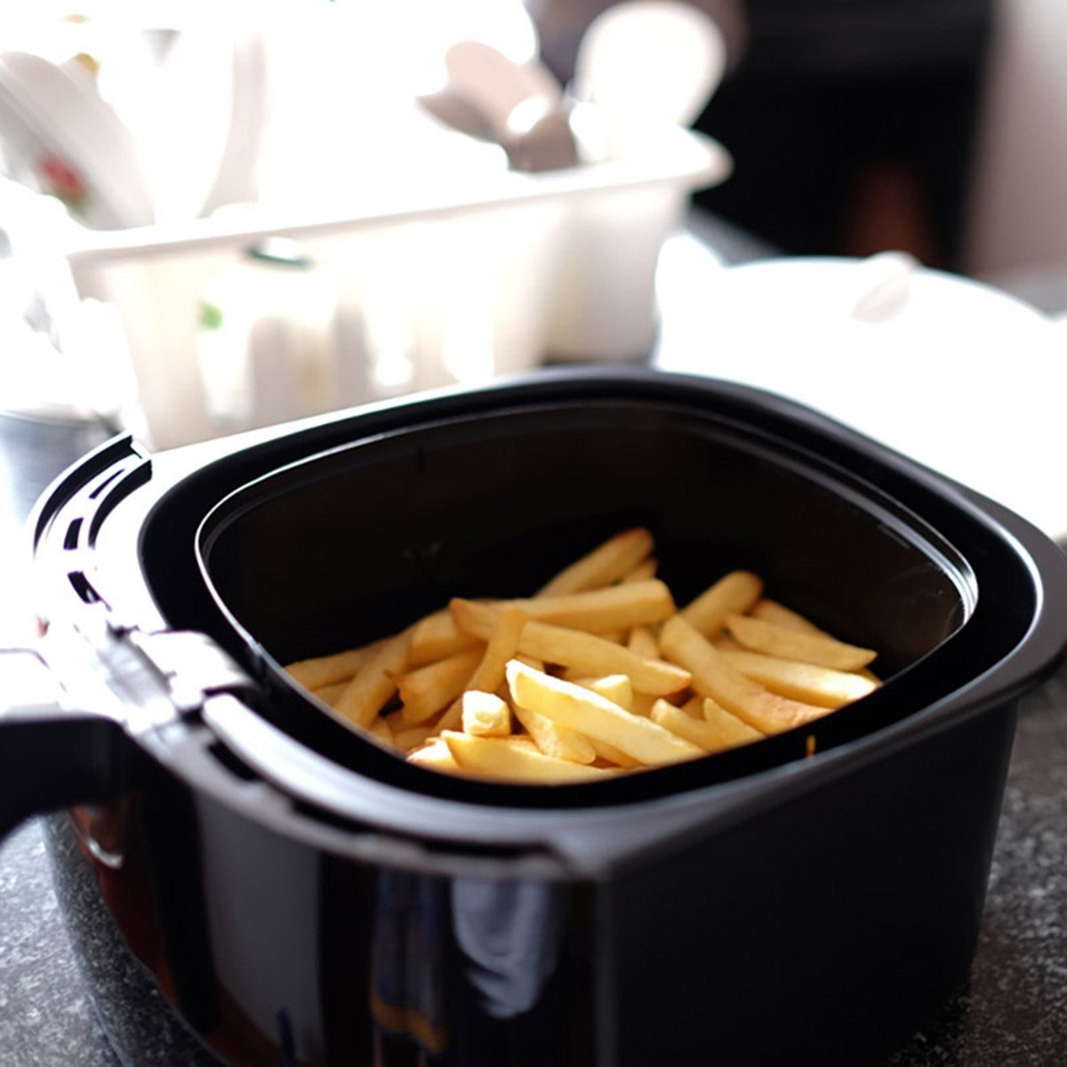 Home-made french fries in modern airfryer