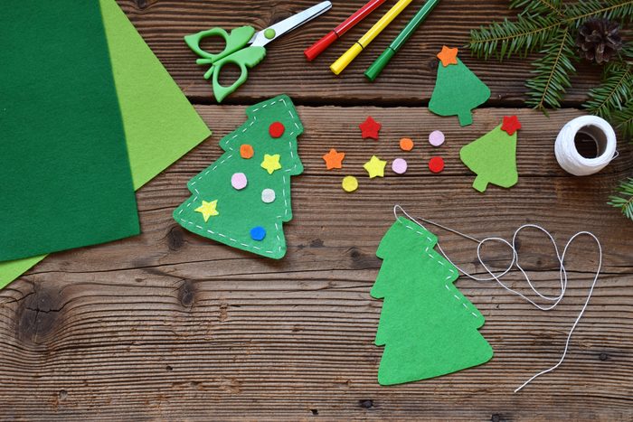 Making of handmade christmas tree from felt with your own hands. Children's DIY concept. Making xmas toys decoration or greeting card.