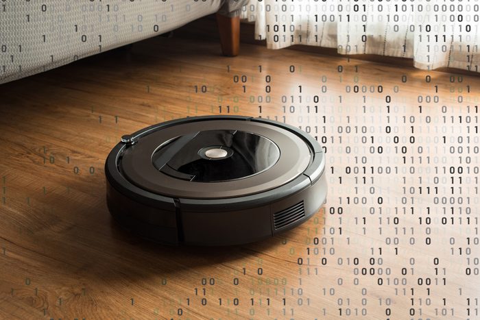 robot vacuum on wood floor with binary computer code overlay