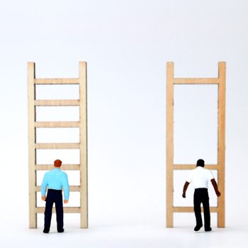 a white figure stands in front of a normal ladder and a Black figure stands in front of a ladder with only three, widely spaced rungs
